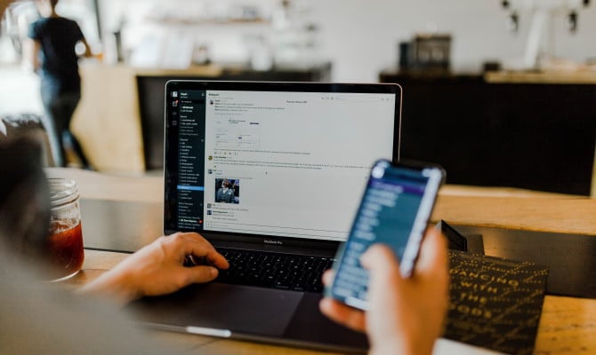 Working on a laptop communicating with team on Slack