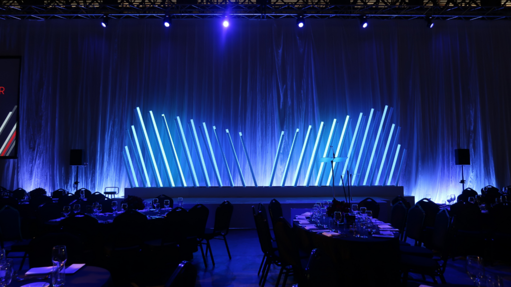 Angled lighting feature stage backdrop for a gala dinner